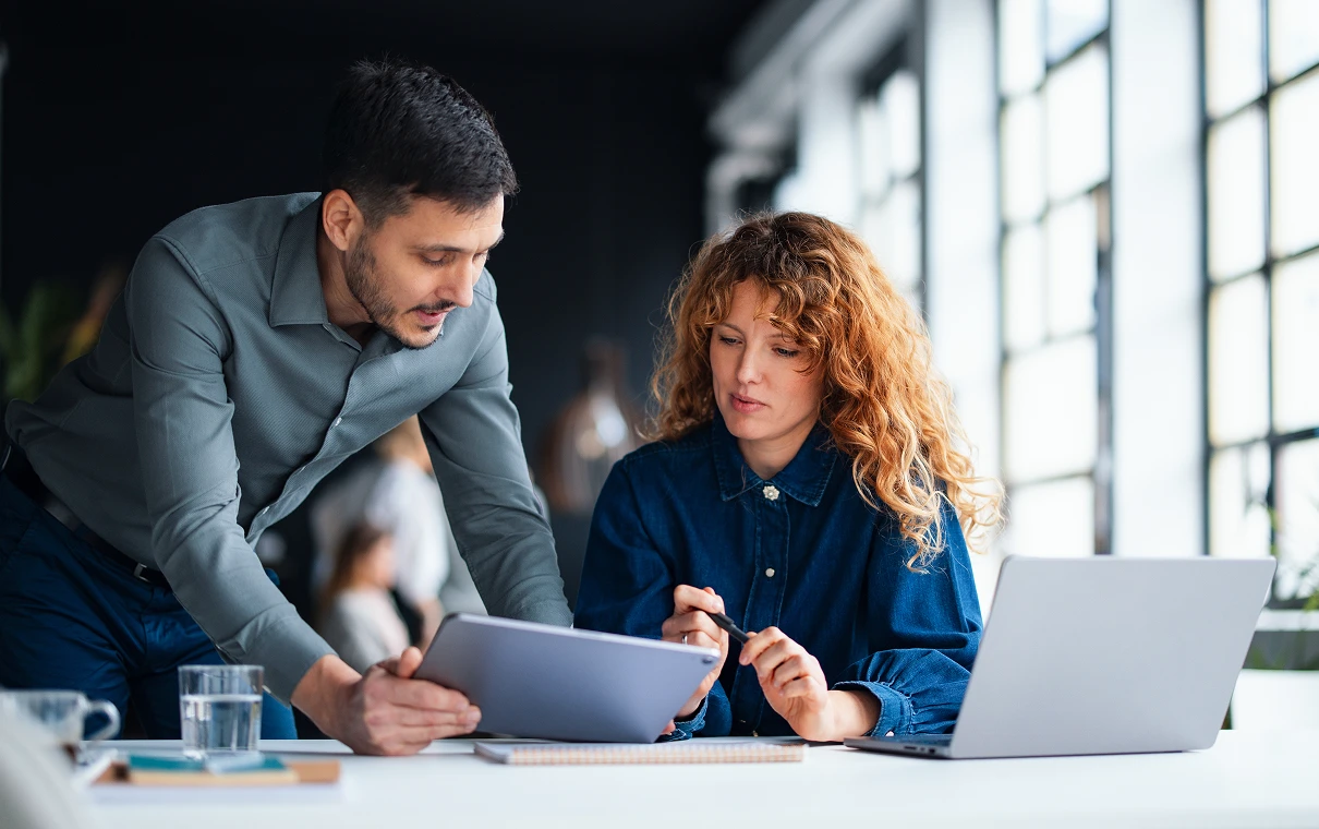 Colleagues discussing work with a tablet