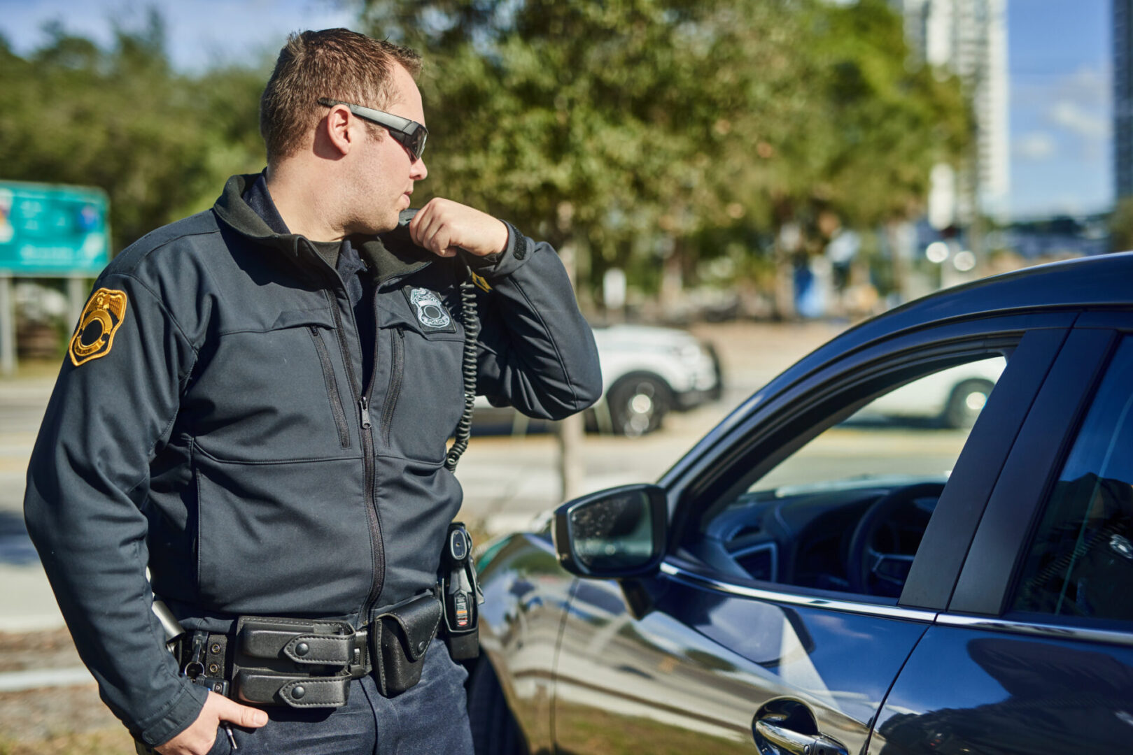 Cropped shot of a handsome young policeman radioing in with headquarters