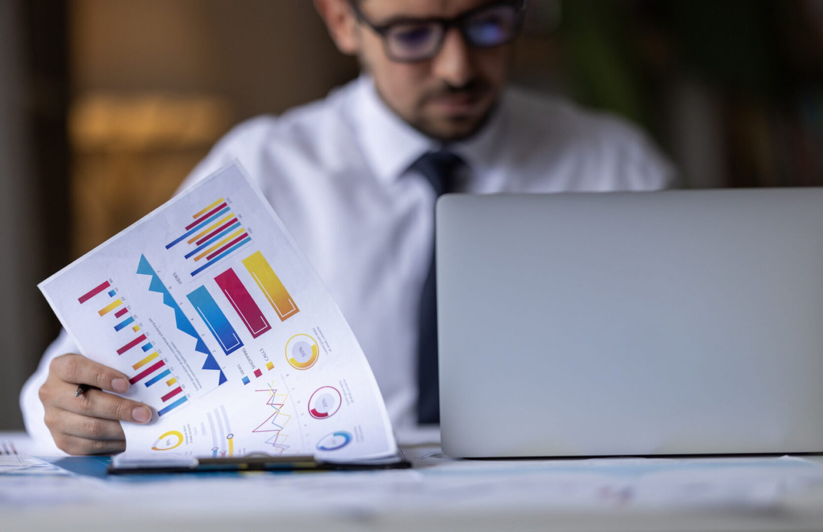 Businessman pointing at financial chart document and statistical market growth analysis. Accounting concepts and financial planning for investment.