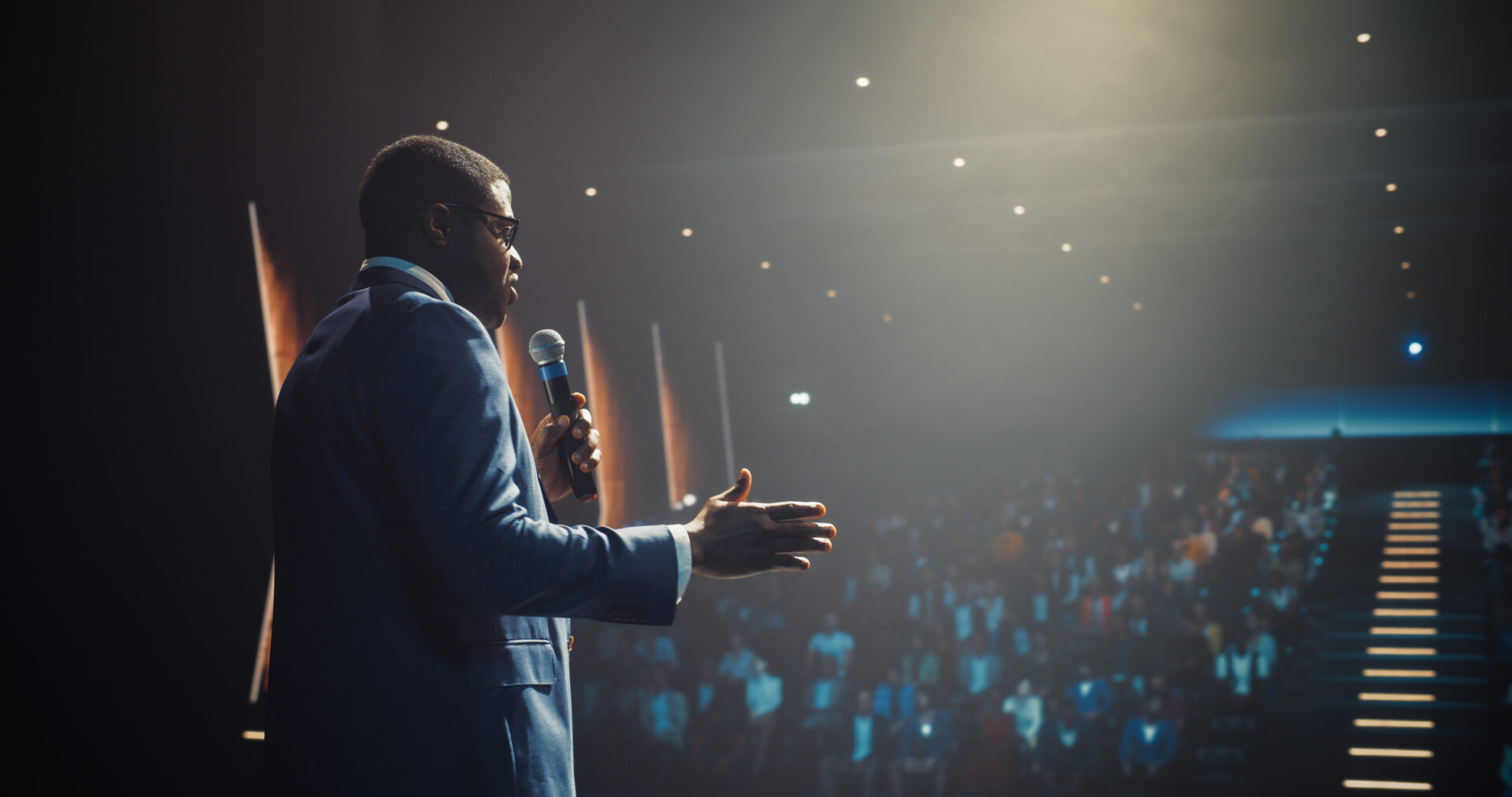African Businessman Speaking at a Global Economic Strategies at International Business Conference. Public Speaker Sharing Professional Knowledge and Leadership Insights. Shot from Behind