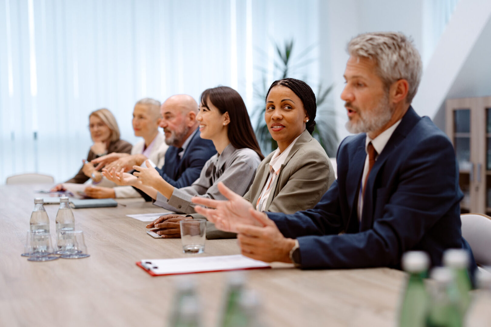 Well dressed colleagues having team meeting at the office board room