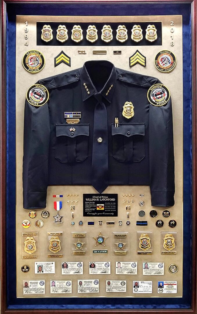 Shadow box of Chief of Police William R. Latchford, Seminole Police Department, 1994 to 2018, with uniform, badges, and credentials