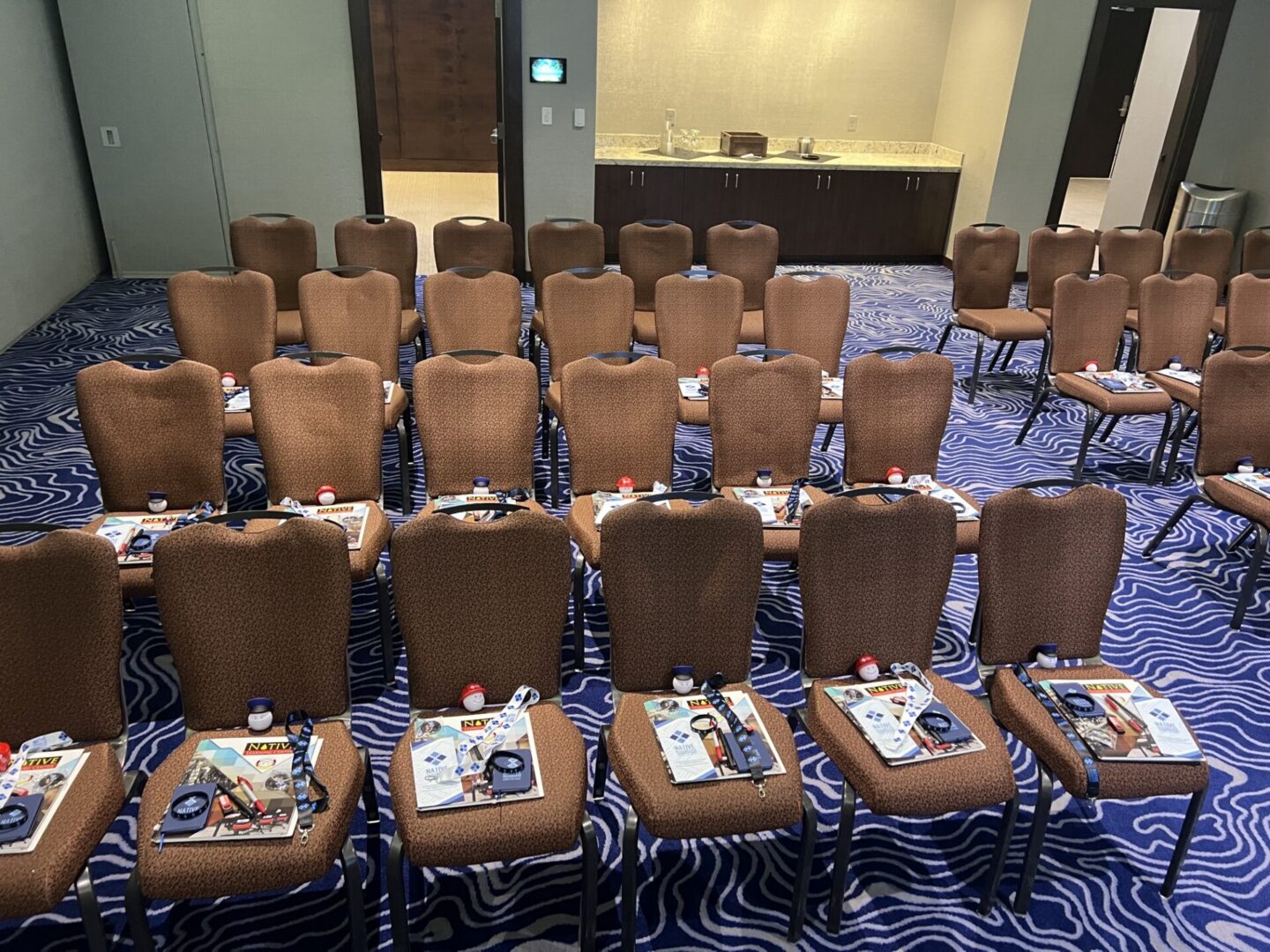 Chairs set with NPKCG workbooks, lanyards, and materials before a training session