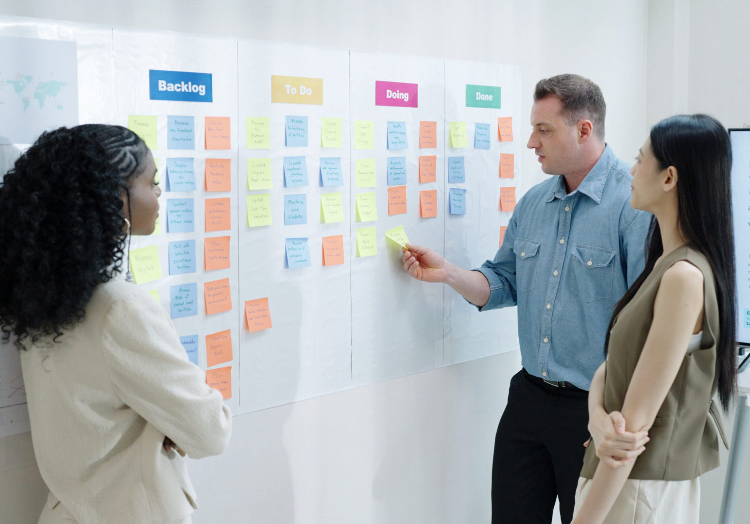 Diverse Collaborative Business people discusses tasks and strategies brainstorming with adhesive note board discuss analyzing data or planning strategies in a modern business technology